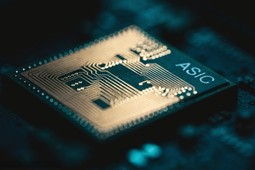 Close-up of a gold-traced AI ASIC chip on a circuit board