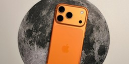An iPhone 17 Pro in cosmic orange resting on a moon-print surface, illustrating on-device local AI